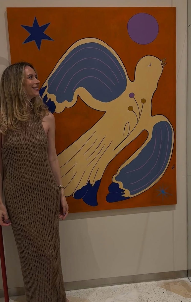 The artist in the gallery, beside Bird on Orange.